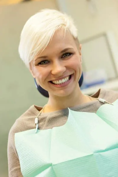 woman showing the results of her smile makeover from Smile Studio Dentistry in Upland, CA