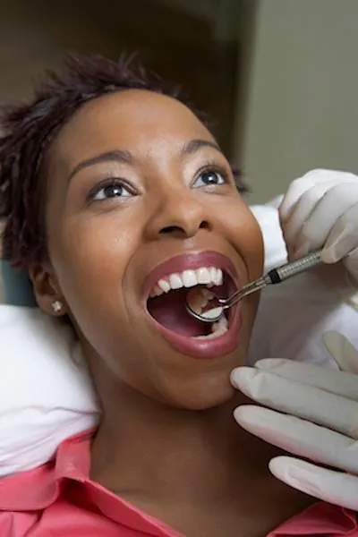 woman receiving an oral examination after her surgery at Smile Studio Dentistry in Upland, CA