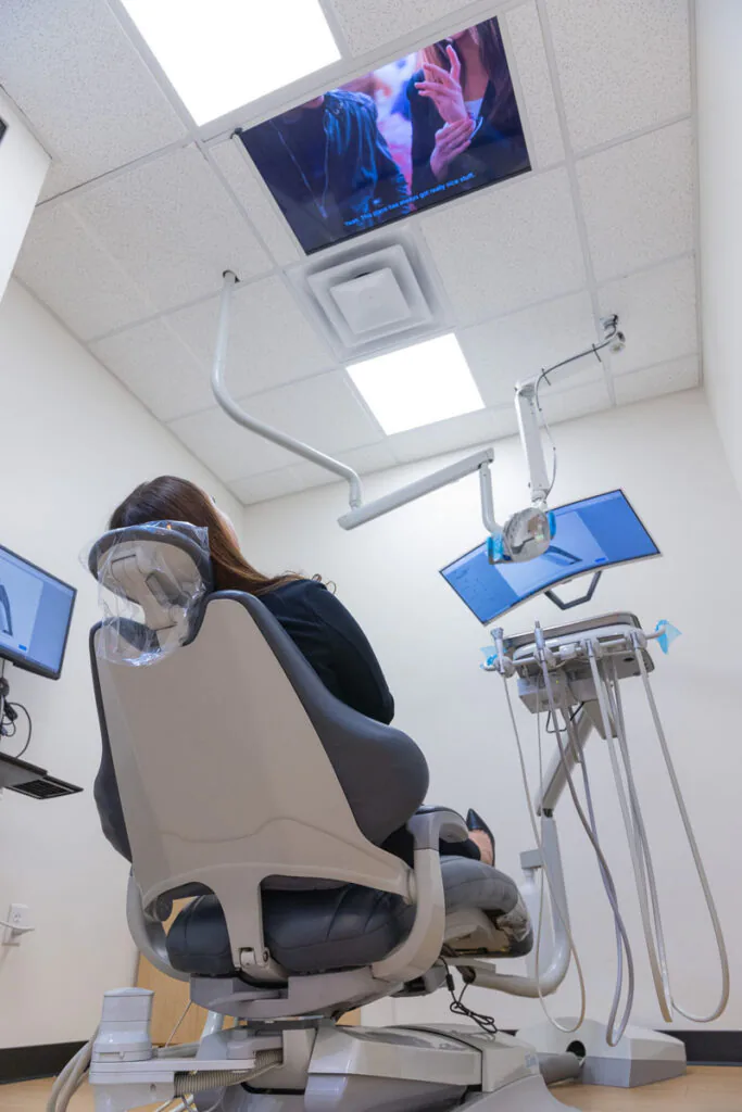 Patient in Smile Studio chair facing ceiling TV