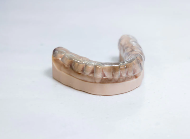 Clear mouthguard on plaster model of teeth