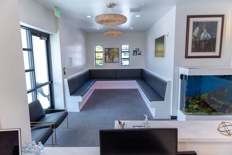 Smile Studio waiting room with bench seating, aquarium